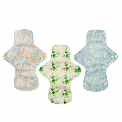 Three floral-patterned sanitary pads on a white background