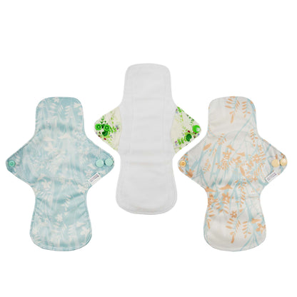 Three reusable menstrual pads with floral patterns on a white background
