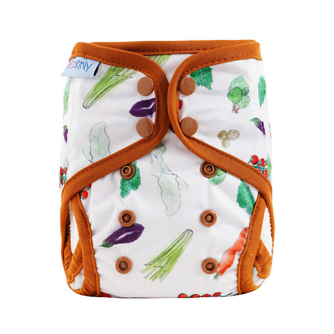 Patterned diaper cover with vegetable design and orange trim on a white background