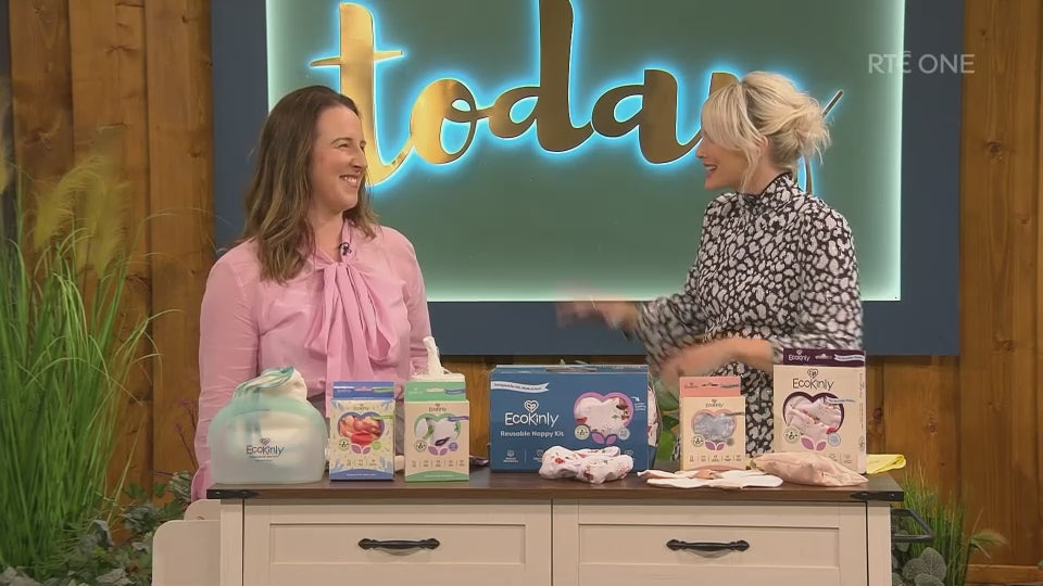 Load video: two ladies showing reusable nappies on tv 