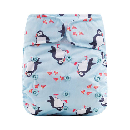 Reusable diaper with penguin pattern on a light blue background